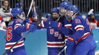 Alex Carpenter (25) of Team United States celebrates with teammates after a goal against Team Czechia in women's ice hockey Group A play during the Milano Cortina 2026 Olympic Winter Games at Milano Rho Ice Hockey Arena.