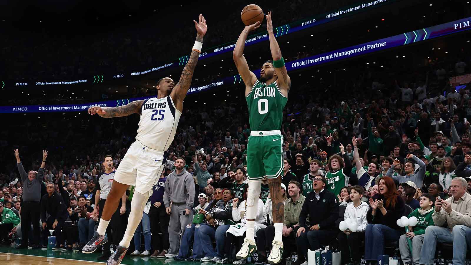 Boston Celtics forward Jayson Tatum (0) shoots past Dallas Mavericks forward P.J. Washington (25) during the second quarter at TD Garden.