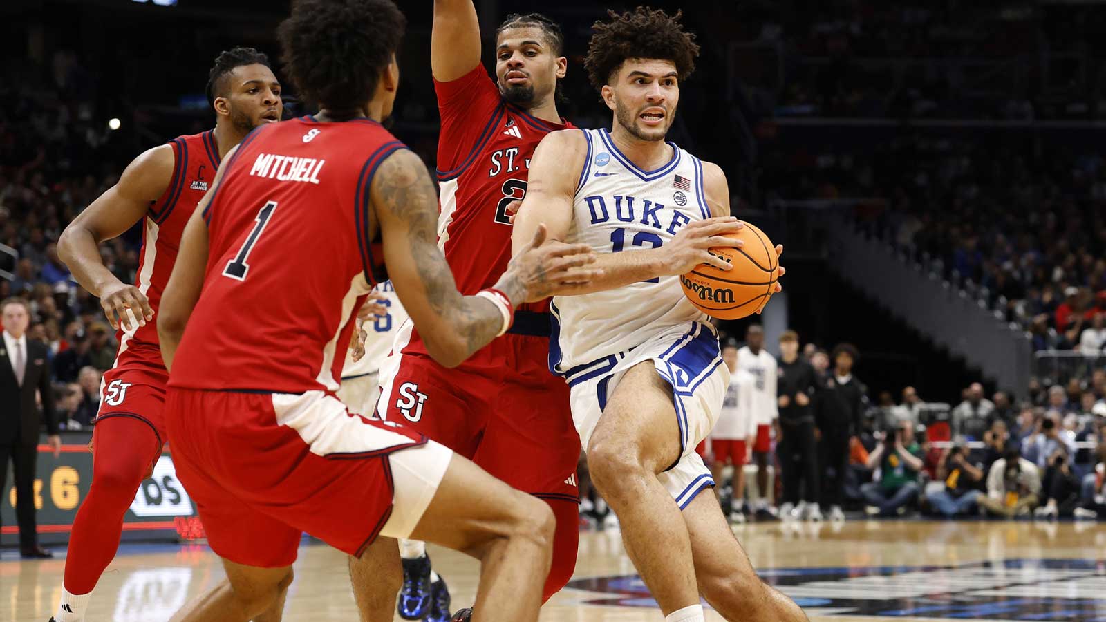Duke Blue Devils forward Cameron Boozer (12) dribbles the ball past St. John's Red Storm forward Zuby Ejiofor (24) in the first half during a Sweet Sixteen game of the East Regional of the men's 2026 NCAA Tournament at Capital One Arena.