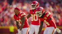 Kansas City Chiefs wide receiver Nikko Remigio (81) and wide receiver Tyquan Thornton (80) and wide receiver Rashee Rice (4) celebrate after a touchdown during the first half against the Las Vegas Raiders at GEHA Field at Arrowhead Stadium.