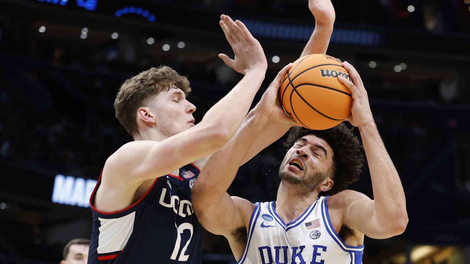 Duke Blue Devils forward Cameron Boozer (12) goes to the basket against UConn Huskies center Eric Reibe (12) in the first half during an Elite Eight game of the East Regional of the men's 2026 NCAA Tournament at Capital One Arena.