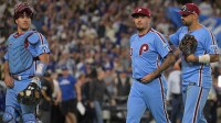 Philadelphia Phillies catcher J.T. Realmuto (10), relief pitcher Orion Kerkering (50) and right fielder Nick Castellanos (8) leave the field after they were defeated by the Los Angeles Dodgers in game four of the NLDS during the 2025 MLB playoffs at Dodger Stadium.