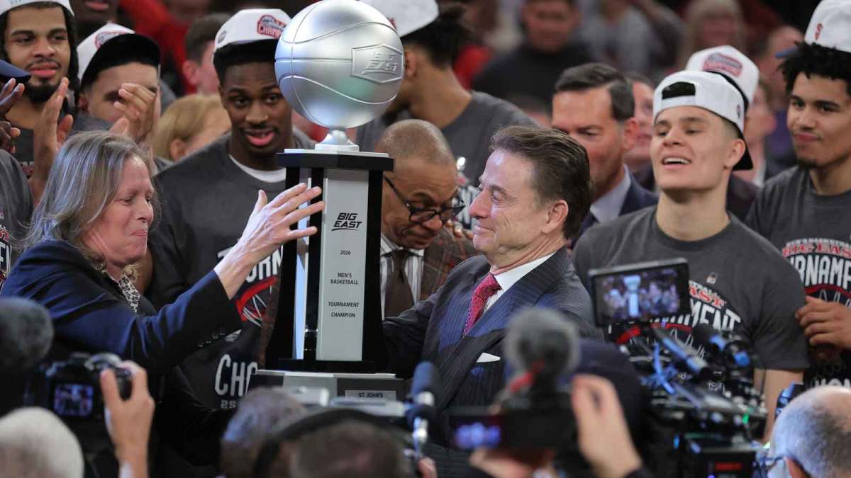 St. John's Red Storm head coach Rick Pitino is presented with the tournament champions trophy after winning the men's Big East Conference Tournament Championship against the Connecticut Huskies at Madison Square Garden.