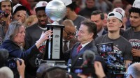 St. John's Red Storm head coach Rick Pitino is presented with the tournament champions trophy after winning the men's Big East Conference Tournament Championship against the Connecticut Huskies at Madison Square Garden.