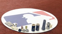 On deck mat with MLB logo and gear in the first inning during a spring training game between the Milwaukee Brewers and the Toronto Blue Jays.