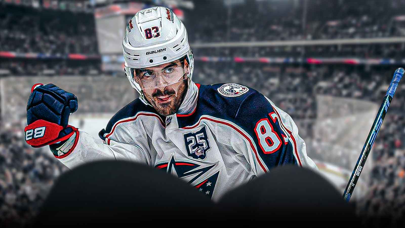 Conor Garland in image looking happy in a Columbus Blue Jackets jersey, hockey rink in background