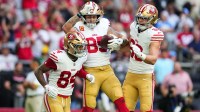 San Francisco 49ers tight end George Kittle (85) celebrates scoring a touchdown with tight end Jake Tonges (88) and wide receiver Kendrick Bourne (84) in the first quarter against the Arizona Cardinals at State Farm Stadium.