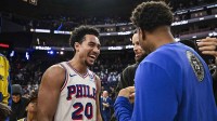 76ers guard Jared McCain (20) smiles post game after defeating the Golden State Warriors at Chase Center with the Thunder logo and Daryl Morey in the background