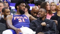 Philadelphia 76ers center Joel Embiid (21) and Tyrese Maxey (R) talk on the bench during the fourth quarter against the Chicago Bulls at Xfinity Mobile Arena.