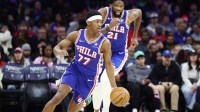 Philadelphia 76ers guard Vj Edgecombe (77) dribbles up court in front of center Joel Embiid (21) during the second quarter against the Chicago Bulls at Xfinity Mobile Arena.