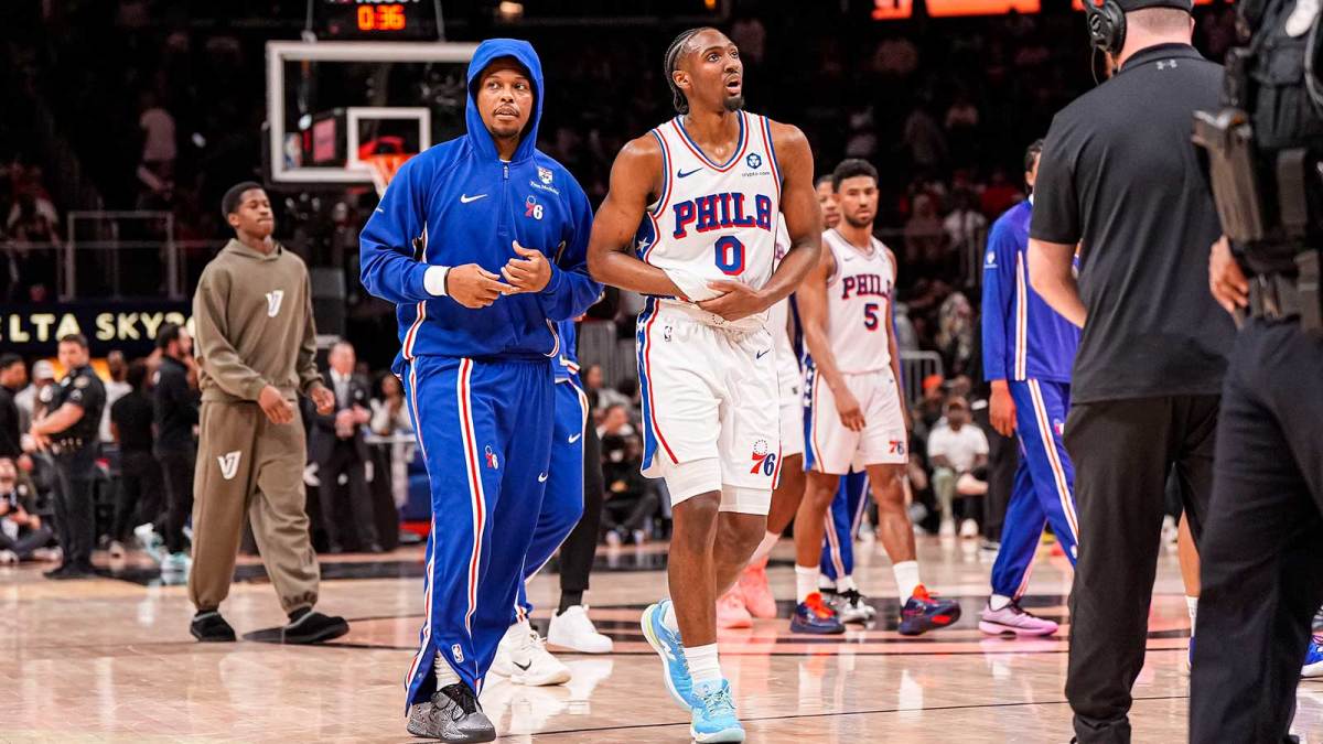 Philadelphia 76ers guard Tyrese Maxey (0) reacts and is assisted after being injured against the Atlanta Hawks during the second half at State Farm Arena.