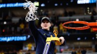 Michigan Wolverines head coach Dusty May cuts the net after defeating Tennessee Volunteers in an Elite Eight game of the Midwest Regional of the men's 2026 NCAA Tournament at United Center.