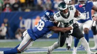 Philadelphia Eagles running back AJ Dillon (29) avoids a tackle by New York Giants linebacker Bobby Okereke (58) during the fourth quarter of the game at MetLife Stadium.