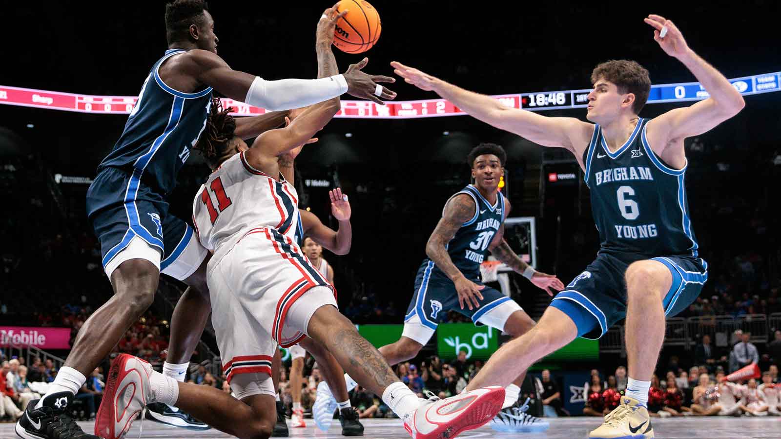 BYU Cougars forward AJ Dybantsa (3) BYU Cougars guard Aleksej Kostic (6) and Houston Cougars forward Joseph Tugler (11) go after a loose ball during the first half at T-Mobile Center.