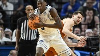 BYU Cougars forward AJ Dybantsa (3) keeps the ball from Texas Longhorns forward Camden Heide (5) in the second half during a first round game of the men's 2026 NCAA Tournament at Moda Center.