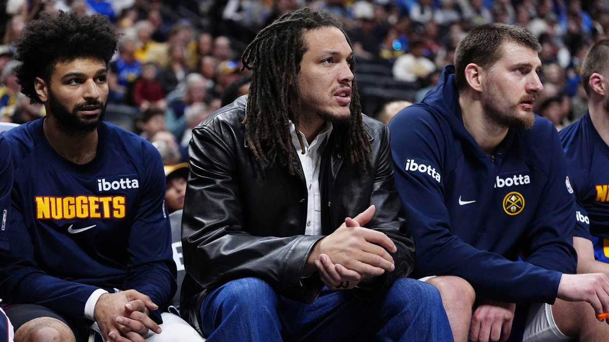 Denver Nuggets guard Jamal Murray (27) and forward Aaron Gordon (32) and center Nikola Jokic (15) on the bench during the second quarter against the Minnesota Timberwolves at Ball Arena.