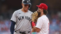 New York Yankees outfielder Aaron Judge (99) with Philadelphia Phillies first base Bryce Harper (3) on first base after his single during the first inning at Citizens Bank Park.