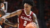 Mar 7, 2026; Tuscaloosa, Alabama, USA; Alabama Crimson Tide guard Aden Holloway (2) dribbles against Auburn Tigers guard Elyjah Freeman (6) during the second half at Coleman Coliseum. Mandatory Credit: David Leong-Imagn Images