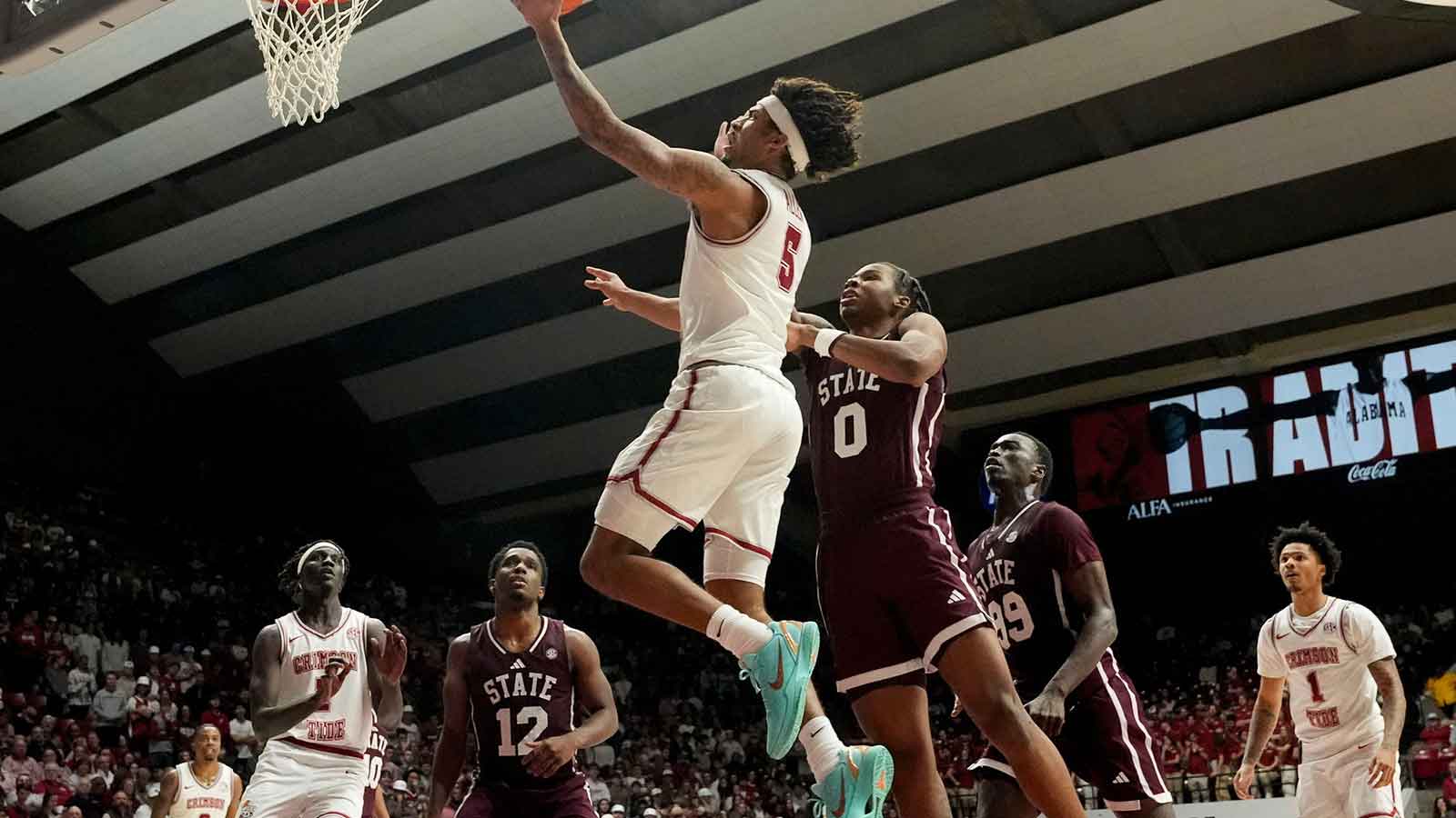 Alabama forward Amari Allen (5) sails to the basket past Mississippi State forward Jamarion Davis-Fleming (0) at Coleman Coliseum. Alabama defeated Mississippi State 100-75.