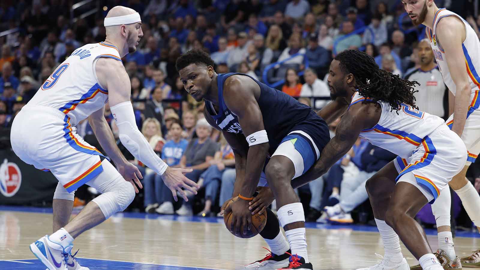 Oklahoma City Thunder guard Cason Wallace (22) reaches to steal the ball away from Minnesota Timberwolves guard Anthony Edwards (5) during the second half at Paycom Center.