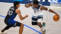 Minnesota Timberwolves guard Anthony Edwards (5) looks to move the ball past Dallas Mavericks guard Max Christie (00) during the first quarter at the American Airlines Center.