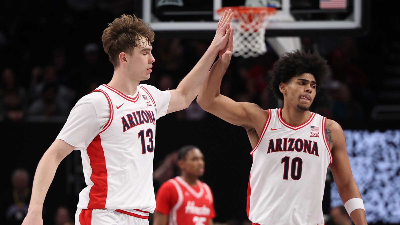 Arizona Wildcats center Motiejus Krivas (13) and forward Koa Peat (10) high-five during the second half against the Houston Cougars during the men's Big 12 Conference Tournament Championship at T-Mobile Center.