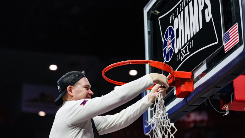 Arizona Wildcats head coach Tommy Lloyd cuts down the net after they defeat the Iowa State Cyclones at McKale Memorial Center.