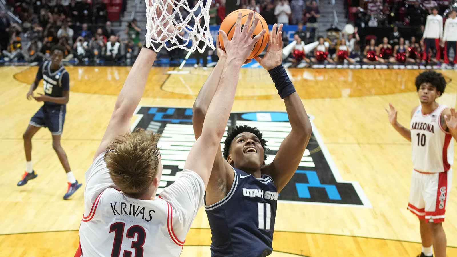 Utah State Aggies forward Garry Clark (11) shoots against Arizona Wildcats center Motiejus Krivas (13) in the second half during a second round game of the men's 2026 NCAA Tournament at Viejas Arena.