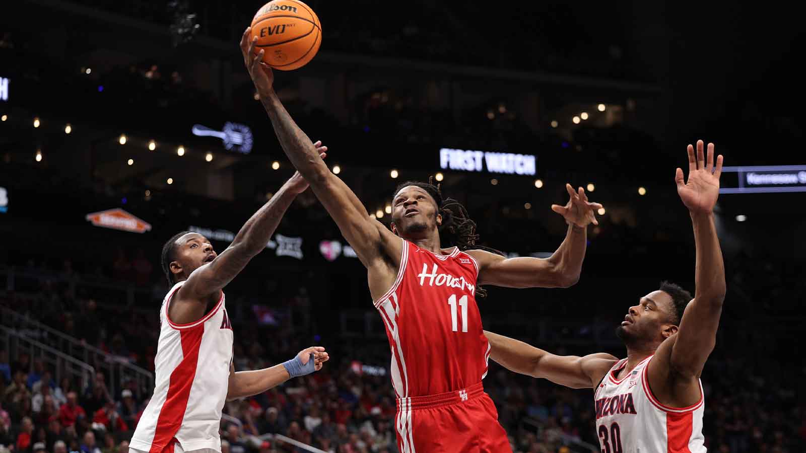 Houston Cougars forward Joseph Tugler (11) drives to the hoop past Arizona Wildcats forward Tobe Awaka (30) during the second half during the men's Big 12 Conference Tournament Championship at T-Mobile Center