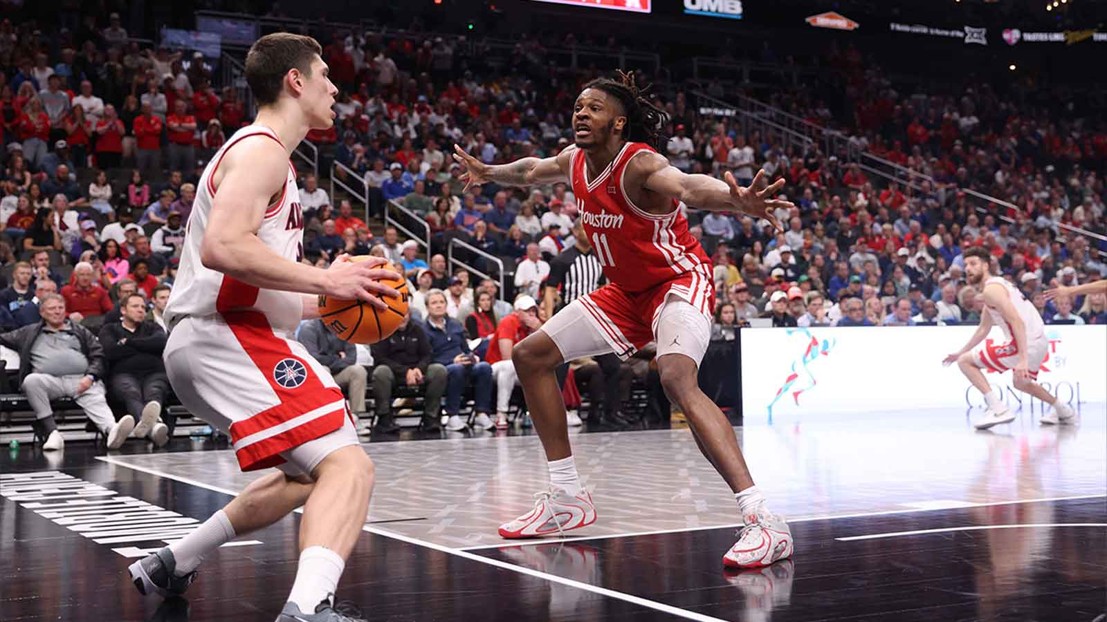 Arizona Wildcats forward Ivan Kharchenkov (8) attempts to inbound the ball past Houston Cougars forward Joseph Tugler (11) during the second half during the men's Big 12 Conference Tournament Championship at T-Mobile Center.