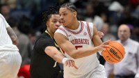 Arkansas Razorbacks guard Darius Acuff Jr. (5) dribbles the ball defended by Vanderbilt Commodores guard Chandler Bing (7) in the second half during the men's SEC Conference Tournament Championship at Bridgestone Arena.