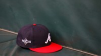 A detailed view of an Atlanta Braves postseason hat on the bench during a workout before the NLDS against the Philadelphia Phillies at Truist Park.