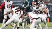 Philadelphia Eagles tight end Dallas Goedert (88) is tackled by Atlanta Falcons cornerback Mike Hughes (21), safety Jessie Bates III (3), and linebacker Troy Andersen (44) during the second quarter at Lincoln Financial Field.