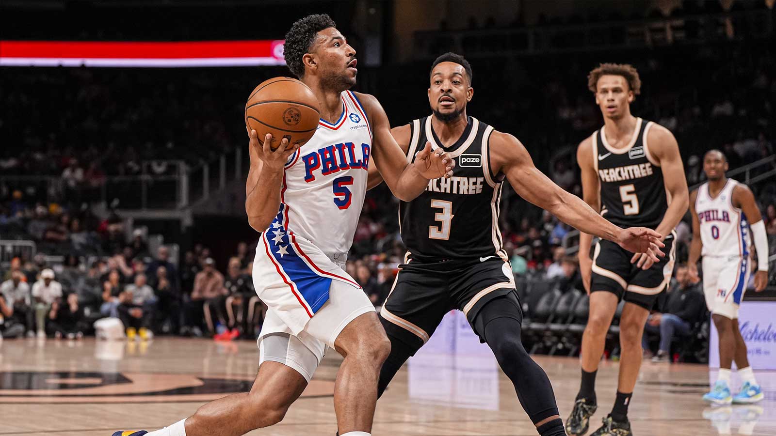 Philadelphia 76ers guard Quentin Grimes (5) drives to the basket against Atlanta Hawks guard CJ McCollum (3) during the first half at State Farm Arena.
