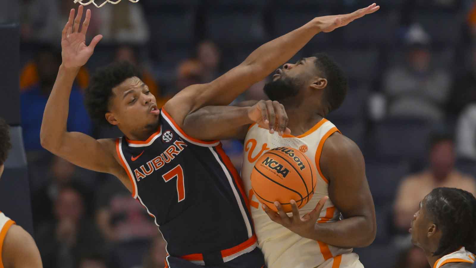 Auburn Tigers guard Keyshawn Hall (7) fouls Tennessee Volunteers guard Grant Hurst (23) during the second half at Bridgestone Arena.