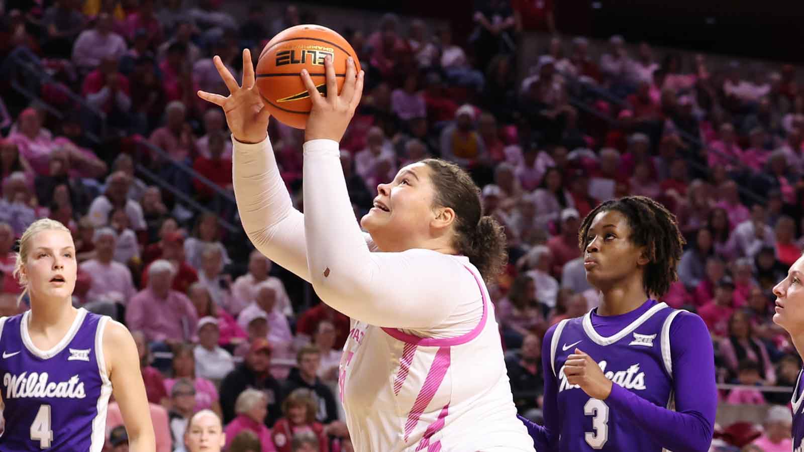 Iowa State Cyclones center Audi Crooks (55) beats Kansas State Wildcats guard Brandie Harrod (3) to the basket during the first half at James H. Hilton Coliseum.
