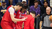 SMU Mustangs guard B.J. Edwards (0) is helped off the court with an apparent injury by center Samet Yigitoglu (24) and guard Jaron Pierre Jr. (5) (obscured) against the California Golden Bears during the first half at Haas Pavilion.