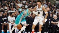 Charlotte Hornets guard LaMelo Ball (1) dribbles against San Antonio Spurs forward Carter Bryant (11) in the second half at Frost Bank Center.