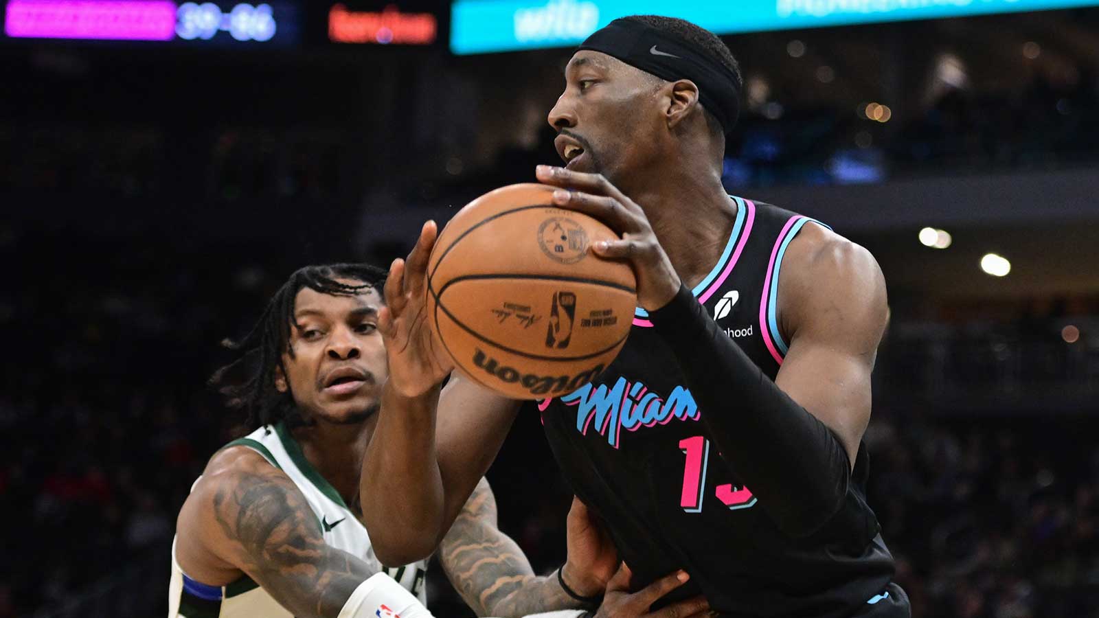 Miami Heat forward Bam Adebayo (13) grabs a rebound against Milwaukee Bucks guard Kevin Porter (7) in the fourth quarter at Fiserv Forum.