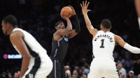 Miami Heat center Bam Adebayo (13) takes a shot over San Antonio Spurs forward Victor Wembanyama (1) during the first half at Kaseya Center.
