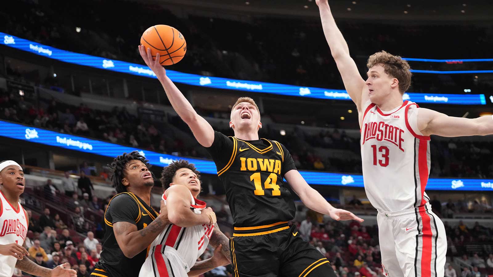 Ohio State Buckeyes center Christoph Tilly (13) defends Iowa Hawkeyes guard Bennett Stirtz (14) during the second half at United Center. 