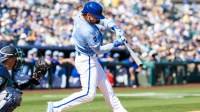 Kansas City Royals shortstop Bobby Witt Jr. hits a double against the Seattle Mariners during a spring training game at Surprise Stadium.