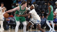 Boston Celtics guard Max Shulga (44) dribbles as Memphis Grizzlies forward Olivier-Maxence Prosper (18) defends during the fourth quarter at FedExForum.
