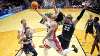 Arizona Wildcats guard Brayden Burries (5) shoots against Utah State Aggies guard Mason Falslev (12) and forward Karson Templin (22) in the first half during a second round game of the men's 2026 NCAA Tournament at Viejas Arena.