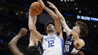 Duke Blue Devils forward Cameron Boozer (12) goes to the basket against UConn Huskies guard Braylon Mullins (24) in the first half during an Elite Eight game of the East Regional of the men's 2026 NCAA Tournament at Capital One Arena.