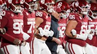 Oklahoma coach Brent Venables locks arms with players before a first-round College Football Playoff game between the University of Oklahoma Sooners (OU) and the Alabama Crimson Tide at Gaylord Family – Oklahoma Memorial Stadium in Norman, Okla., Friday, Dec. 19, 2025.