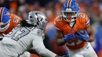 Denver Broncos running back J.K. Dobbins (27) rushes the ball against the Las Vegas Raiders during the second half at Empower Field at Mile High.
