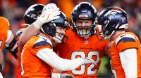 Denver Broncos place kicker Wil Lutz (3) celebrates with tight end Adam Trautman (82) and punter Jeremy Crawshaw (16) after kicking a game-winning field goal during overtime of an AFC Divisional Round playoff game against the Buffalo Bills at Empower Field at Mile High.