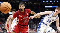 St. John's Red Storm forward Bryce Hopkins (23) and Duke Blue Devils guard Nikolas Khamenia (14) attempt to get a rebound in the second half during a Sweet Sixteen game of the East Regional of the men's 2026 NCAA Tournament at Capital One Arena.