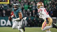 Philadelphia Eagles quarterback Jalen Hurts (1) runs under pressure from San Francisco 49ers defensive end Bryce Huff (47) during the fourth quarter in an NFC Wild Card Round game at Lincoln Financial Field.